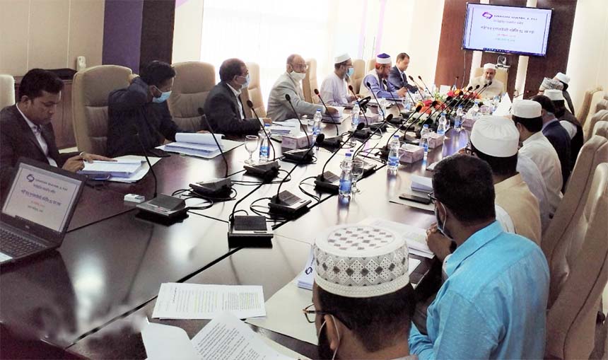 Professor Md. Mozahidul Islam Chowdhury, Chairman of the Shari'ah Supervisory Committee of Union Bank Limited, presiding over a meeting on Monday at its head office. A B M Mokammel Hoque Chowdhury, Managing Director of the bank and other members of the c