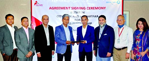 Md. Mahbubur Rahman, DMD and CFO of City Bank Limited and Md. Mahmud Al Maruf Toufiq, Managing Director of Aamartaka.com, exchanging an agreement signing document at the bank head office in the city on Wednesday. Under the deal, Aamartaka.com will act as