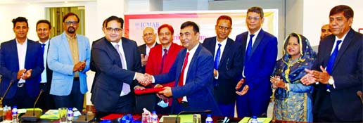 Md. Jasim Uddin Akond, President of ICMAB and Shams Mahmud, President of DCCI, exchanging the MoU signing document at ICMAB Bhaban in the city on Tuesday.