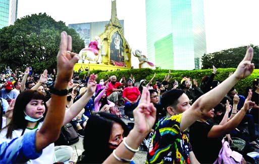 Pro-democracy protesters give the three-finger salute during an anti-government rally outside the headquarters of the Siam Commercial Bank, in Bangkok on Wednesday.