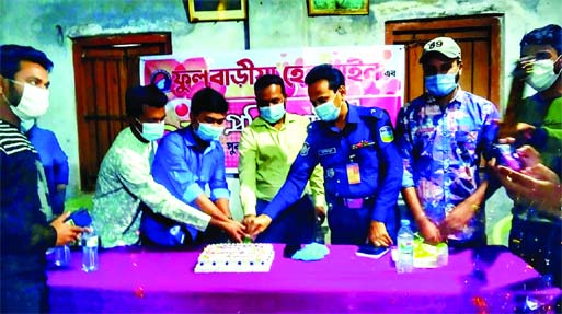 Mymensingh's Fulbaria UNO Asraful Siddique cuts a cake on Wednesday marking the second anniversary of Fulbaria Helpline.