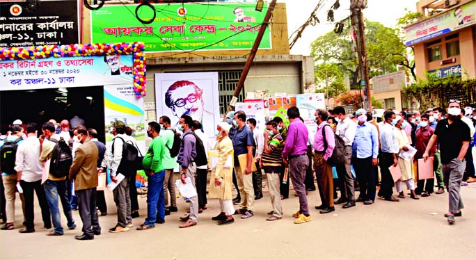 People form a long queue in front of Tax Commissioner's office (Tax Zone-11) to file their returns on Thursday with total disregard to physical distancing norm amid rising fatalities from Covid-19 in the country.