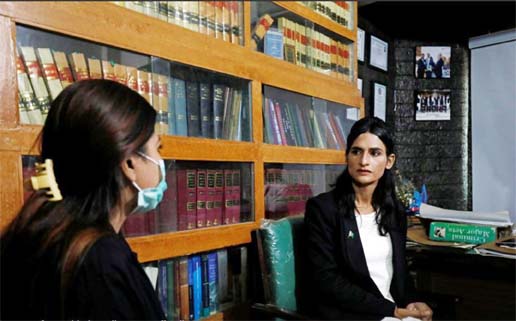 Nisha Rao, 28, a transgender woman who became country's first practicing lawyer, listens to one of her clients at office in Karachi, Pakistan.