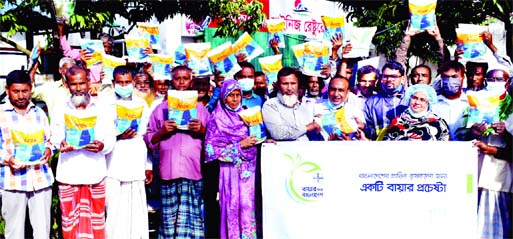 Officials of Bayer Crop Science and farmers pose for a photograph after the free paddy seed distribution ceremony held at the Green Resort premises in Bogura on Friday.