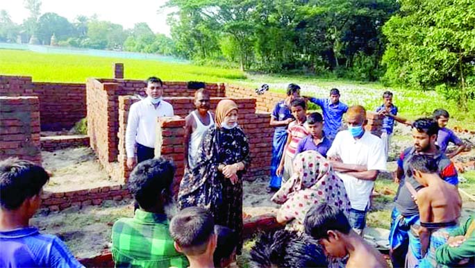 Bijoynagar (Brahmanbaria) Upazila Chairman Nasima Lutfar Rahman inspects the progress of the construction work of houses to be provided to the homeless people of Budhanti village in the upazila on Sunday.