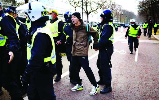 Police officers detain an anti-lockdown protestor during a demonstration amid the Covid-19 outbreak, in London on Saturday.
