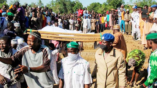 Mourners attend the funeral of 43 farm workers in Zabarmari, about 20km from Maiduguri, Nigeria, after they were killed by Boko Haram fighters.