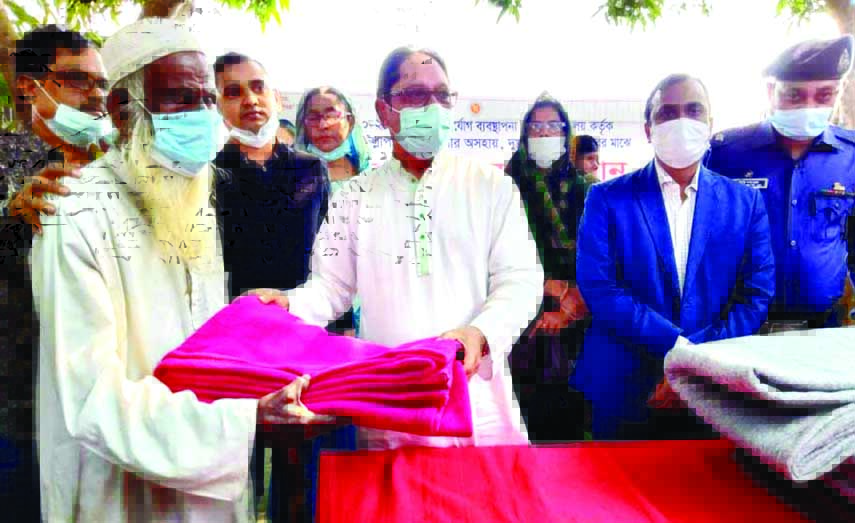 Tanveer Imam, MP, distributes warm cloths among the helpless people in Ullapara of Sirajganj district on Tuesday.