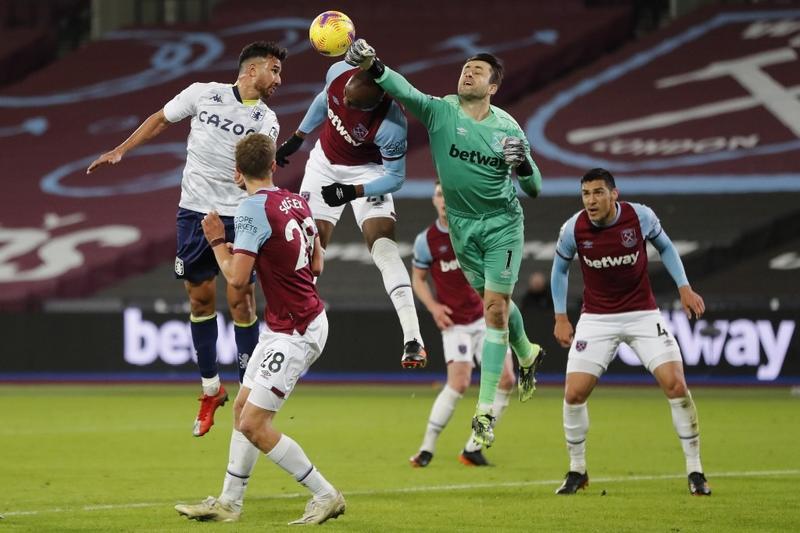 West Ham United's Polish goalkeeper Lukasz Fabianski (center) punches the ball during the English Premier League football match between West Ham United and Aston Villa at the London Stadium in east London on Monday.