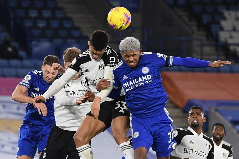 Fulham's English-born US defender Antonee Robinson (center) and Leicester City's French defender Wesley Fofana (right) compete for the ball during the English Premier League football match between Leicester City and Fulham at King Power Stadium in Leice