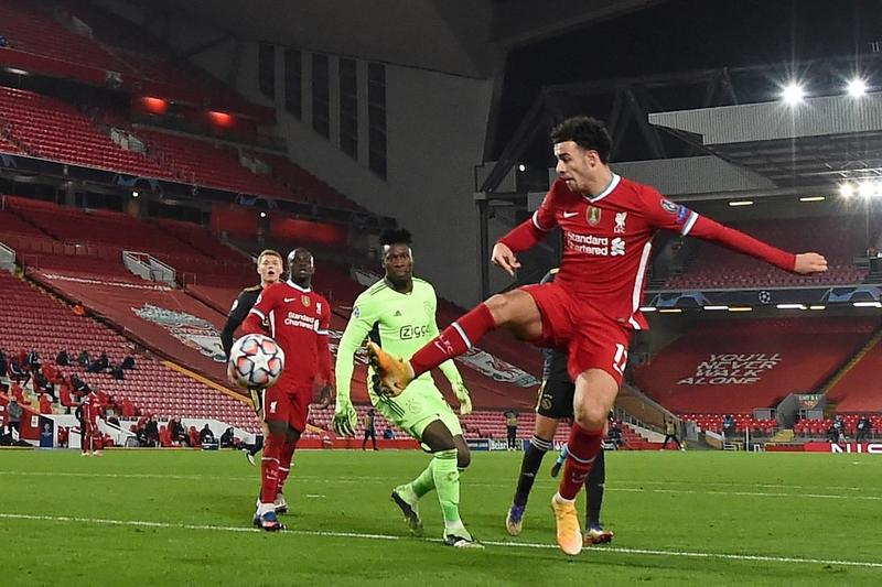 Liverpool's midfielder Curtis Jones (right) scores the opening goal during the UEFA Champions League, Group D football match against Ajax at Anfield in Liverpool, north west England on Tuesday.