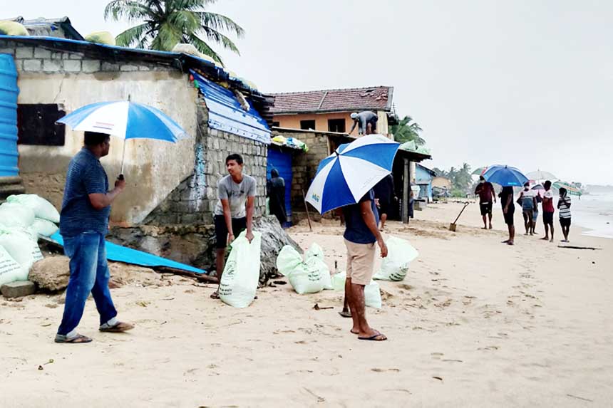 Residents prepare sand bags to protect their homes ahead of cyclone Burevi landfall in Sri Lanka's north-eastern coast in Trincomalee.