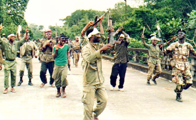 Fighters in the United Liberation Movement (ULIMO) perform a war dance on the Po River bridge, in Monrovia.