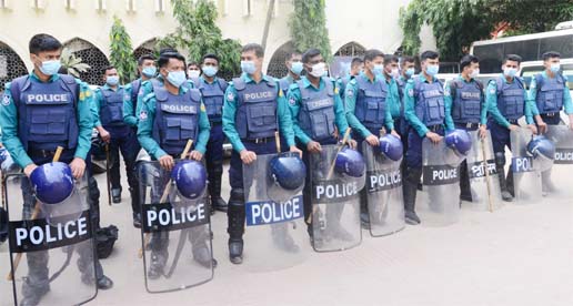 Law enforcers stand guard to tackle any violence as ban on imposed on procession and rally without permission. The snap was taken from Baitul Mokarram National Mosque on Friday.