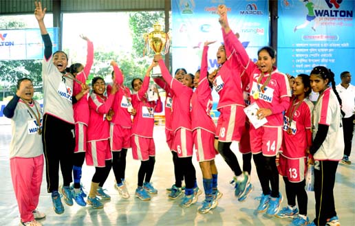 Players of Bangladesh Ansar & VDP celebrating with the champions trophy after defeating Bangladesh Police Handball Club in the final of the Walton 1st Federation Cup Women's Handball Competition at the Shaheed (Captain) M Mansur Ali National Handball Sta