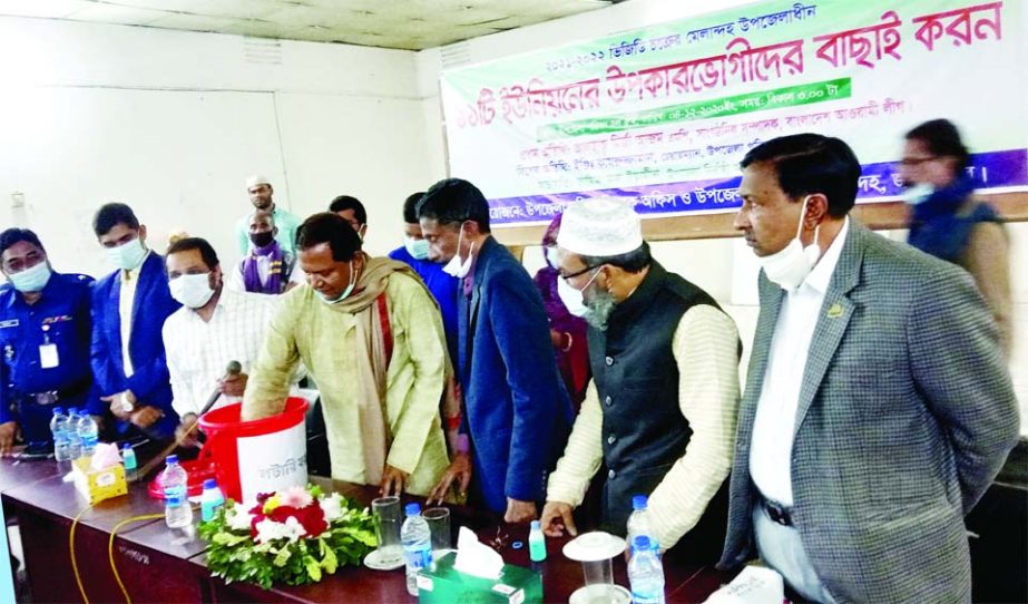 Mirza Azam, MP, picks up lotteries to select members of VGD beneficiaries at a function held at the Melandah Upazila Parishad Hall Room in Jamalpur on Friday.