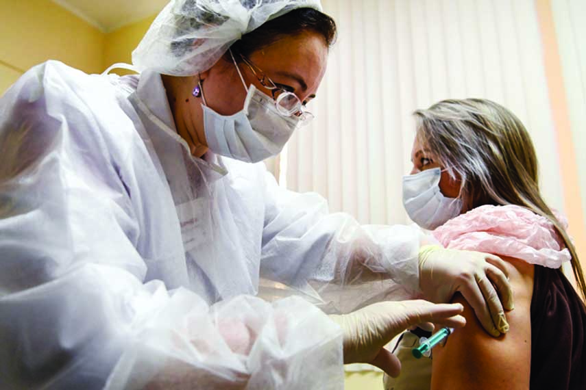 A nurse wearing a face mask proceeds to a vaccination against the coronavirus by Sputnik V vaccine at a clinic in Moscow, Russia.