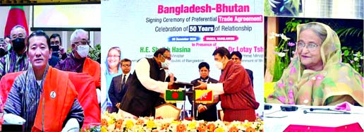 Commerce Minister Tipu Munshi and Lyonpo Lonath Sharma, Economic Affairs Minister on Sunday, exchanging the Preferential Trade Agreement (PTA) signing document between Bangladesh and Bhutan virtually marking the 50th year of the recognition of both countr