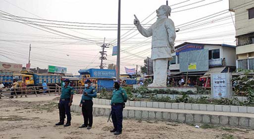 Police stand guard around the Bangabandhu's sculpture at Halishahar in the port city on Monday.