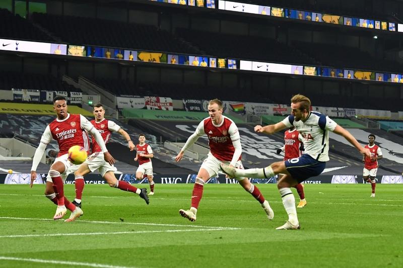 Tottenham Hotspur's English striker Harry Kane (right) scores his team's second goal during the English Premier League football match between against Arsenal at Tottenham Hotspur Stadium in London on Sunday.