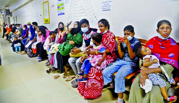 Hospitals across Dhaka are witnessing a huge influx of patients as winter illnesses continue to take a toll on public life. This photo taken on Monday from capital's Shishu Hospital shows that parents wait at the outpatient department (OPD) of the public