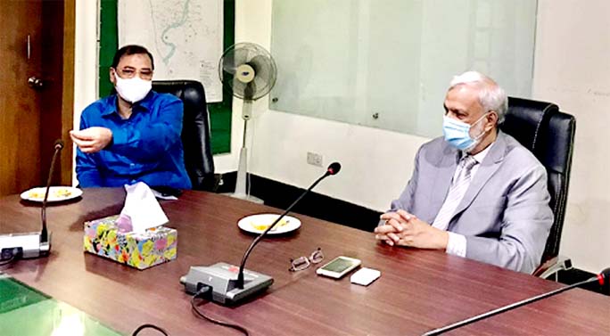 Former city mayor AJM Nasiruddin is seen exchaging views with CDA chairman Zahirul Alam Dobash at latter's conference room yesterday.