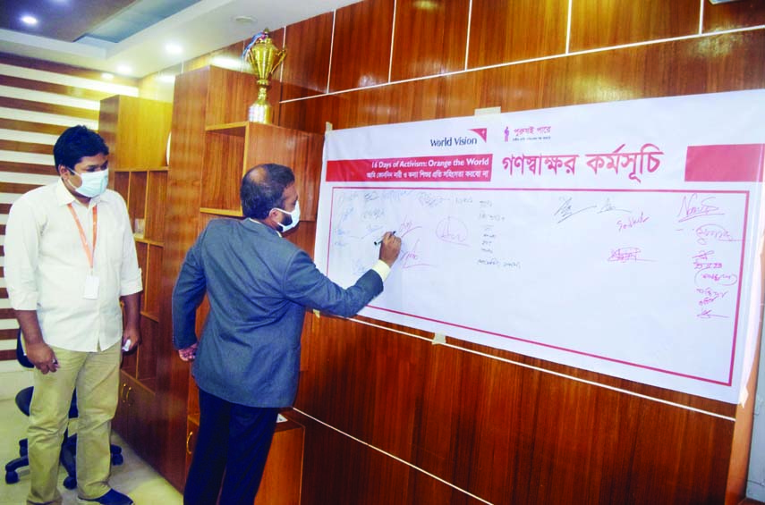 Asraful Siddique, UNO of Fulbaria (Mymensingh) takes part to a mass signature campaign titled "I will never repress woman and girl child' at his office on Tuesday.