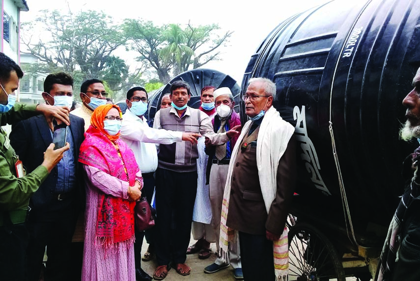 Advocate Shah-E-Alam Bachchu, Upazila Chairman of Morelganj in Bagerhat along with UNO Md Delwar Hossain distribute water tank among the families of insolvent freedom fighters in the area on Tuesday.