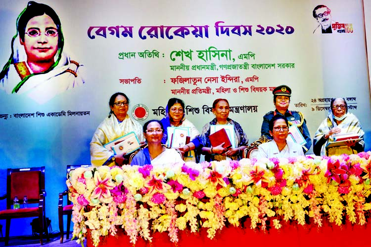 State Minister for Women and Children Affairs Fazilatun Nesa Indira poses for a photo session with the recipients of citation, certificates and cheques in Shishu Academy auditorium in the city on Wednesday marking Begum Rokeya Day.