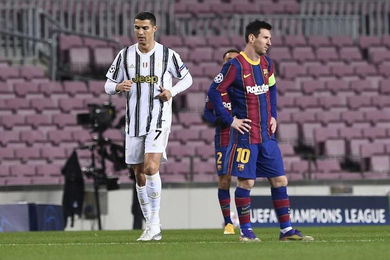 Juventus' Portuguese forward Cristiano Ronaldo (left) walks past Barcelona's Argentinian forward Lionel Messi during the UEFA Champions League, group G football match at the Camp Nou stadium in Barcelona on Tuesday.