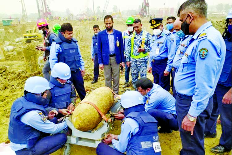 Members of the bomb disposal unit of Bangladesh Air Force (BAF) examine a cylinder-like bomb, which was found while digging earth for the under-construction third terminal of the Hazrat Shahjalal International Airport on Wednesday.