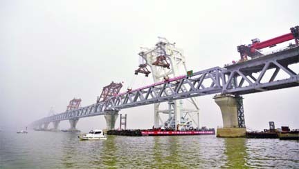 A specialised floating crane installs the 41st and last span of the much-hyped Padma Bridge on its 12 and 13 piers at the Mawa side in Munshiganj district on Thursday morning, making the whole 6.15-km mega structure visible.