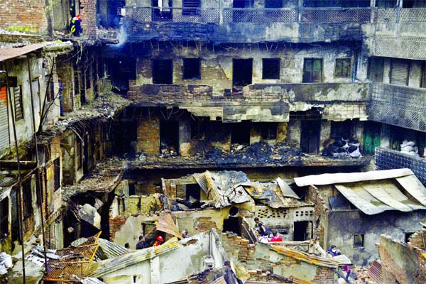 A massive fire destroys a four-story building housing dozens of plastic factories and stores of raw materials in the capital's Chawkbazar area early on Friday. The burn building is seen after the devastating fire.