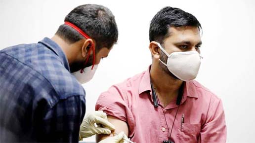 A medic administers COVAXIN, an Indian government-backed experimental COVID-19 vaccine, to a health worker during its trials, at the Gujarat Medical Education & Research Society in Ahmedabad.