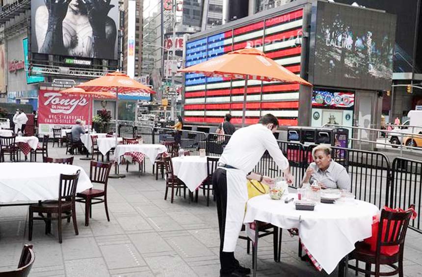 Servers package food at a table at a pop up restaurant set up in Times Square for 'Taste of Times Square Week' during the coronavirus pandemic in the Manhattan borough of New York City, US.