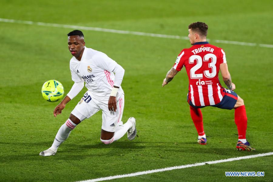 Real Madrid's Vinicius Jr. (left) vies with Atletico de Madrid's Kieran Tripper during a Spanish football league match between Real Madrid and Atletico de Madrid, in Madrid, Spain on Saturday.