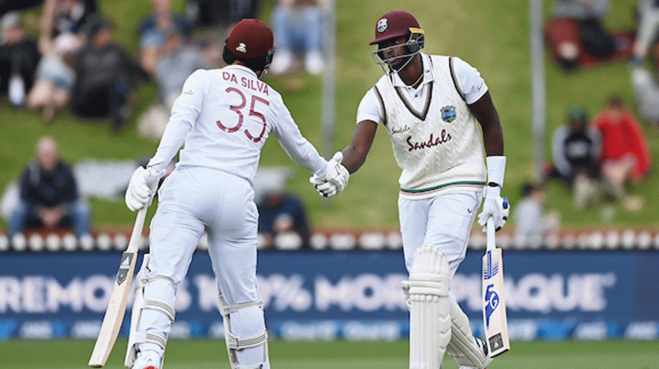 Jason Holder (right) and Joshua da Silva of West Indies shaking hands during their 73-run unbroken partnership against New Zealand in Wellington on Sunday.
