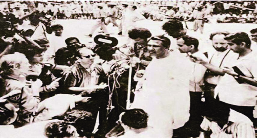 Tajuddin Ahmed, Prime Minister of Mujibnagar Government of Bangladesh is seen speaking to the world press regarding War of Liberation. Barrister Ameer ul Islam (bearded) is seen behind Mr. Tajuddin Ahmed with Journalists from around the world.