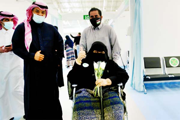 A Saudi woman gestures after she received the first dose of a coronavirus vaccine.