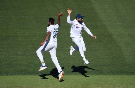 Captain of India Virat Kohli (right) celebrates with bowler Ravichandran Ashwin (left) after dismissal of an Australian wicket on day 2 of the first Test match between Australia and India at Adelaide Oval in Adelaide, Australia on Friday.