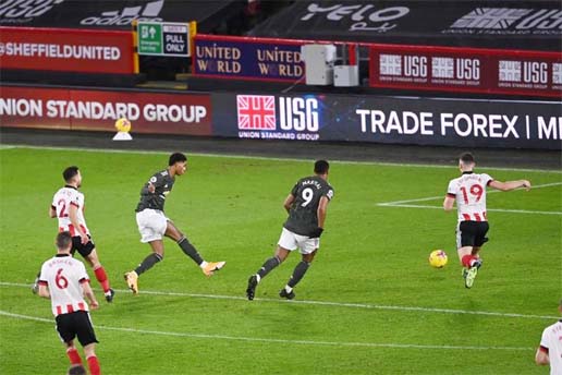 Manchester United's English striker Marcus Rashfordm (third from left) scores his team's third goal during the English Premier League football match between Sheffield United and Manchester United at Bramall Lane in Sheffield, northern England on Thursda