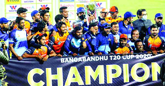 Members of Gemcon Khulna, the champions in the Bangabandhu T20 Cup Cricket pose with the winning trophy at the flood-lit Sher-e-Bangla National Cricket Stadium in the city's Mirpur on Friday.