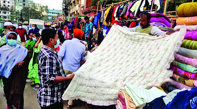 People throng to buy winter cloths at footpath shops near New Market in the port city Chattogram on Saturday amid mild cold wave Sweeps across the country.