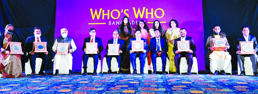 Foreign Minister Dr AK Abdul Momen poses for a photo session with the recipients of 'WHO'S WHO' Bangladesh Awards at a hotel in the city on Saturday.