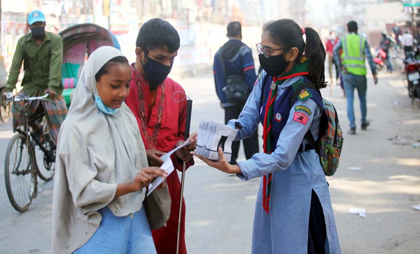 Bangladesh Scouts distributes masks among the common people in the city's Topkhana Road on Saturday with a view to resisting second wave of Corona virus.