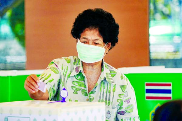 A woman casts her vote at a polling station during provincial elections in Prachuap Khiri Khan province in Thailand on Sunday.