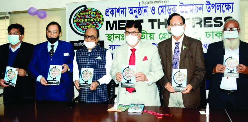 President of Jatiya Press Club Saiful Alam along with others holds the copies of a book titled 'Ami Corona Virus Balchhi' written by former Joint Secretary Rafiqul Islam Akanda at its cover unwrapping ceremony in the auditorium of JPC on Monday.