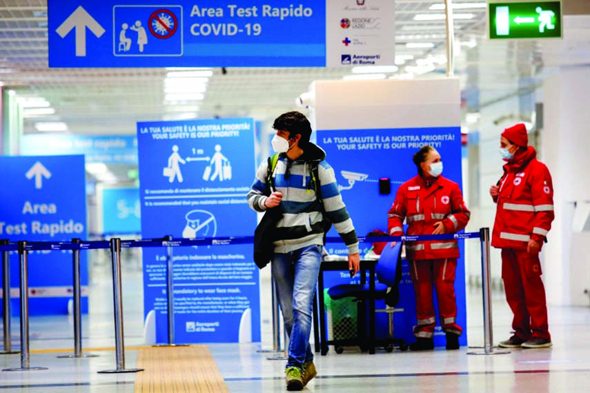 A passenger walks at Fiumicino airport in Rome after the Italian government announced all flights to and from the UK will be suspended over fears of a new strain of the coronavirus.