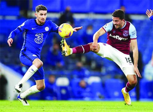 Chelsea's Jorginho (left) and West Ham's Pablo Fornals compete for the ball during the English Premier League soccer match between Chelsea and West Ham at Stamford Bridge, London on Monday.