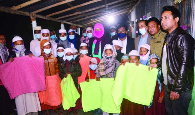 Kurigram's Ulipur Upazila Nirbahi Officer (UNO) Nur-e-Jannat Rumi distributes blankets among the orphan children at a ceremony on Monday night.